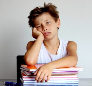 A student sits frustrated in class because he doesn't understand his basic math facts.