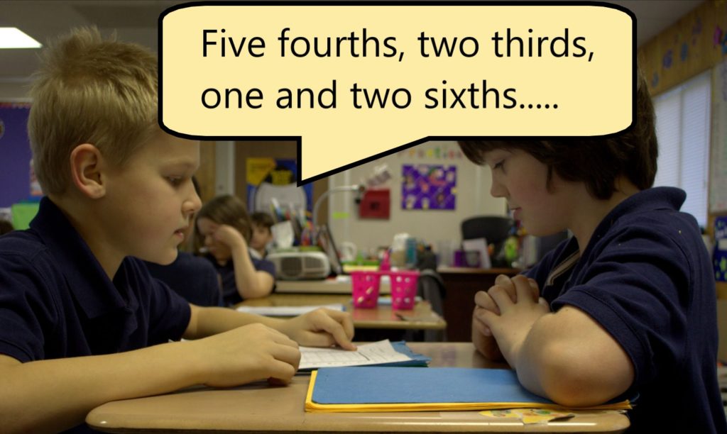 Two students are using 4th grade math worksheets in class by asking each other a math question and testing each other.